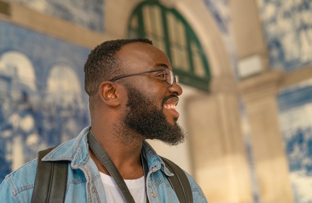 Happy tourist man against azulejo