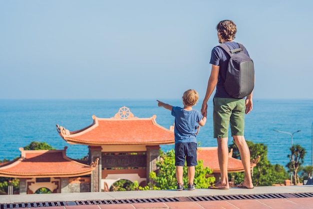 Happy tourists dad and son in pagoda travel to asia concept traveling with a baby concept