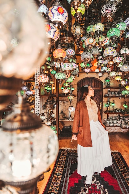 Happy travel woman choosing Amazing traditional handmade turkish lamps 