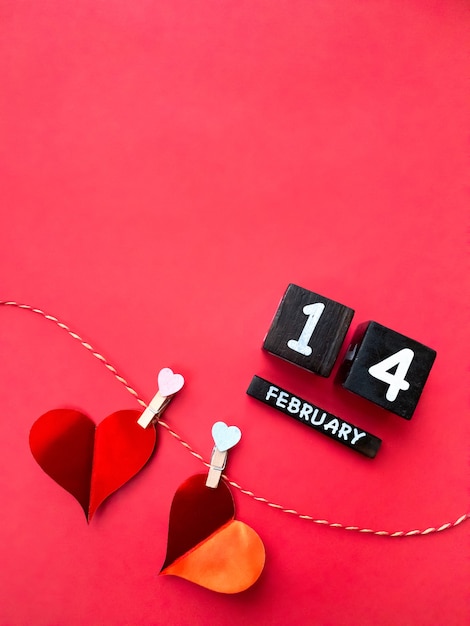 Happy valentines day 2021. Calendar and hearts on red background