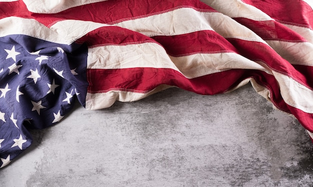 Happy Veterans Day concept. American flags against a dark stone  background. November 11.