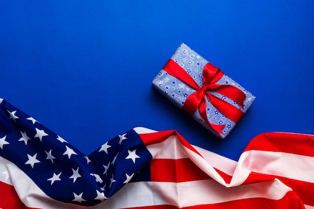 Happy Veterans Day concept American flags with gift box against a blackboard background November 11