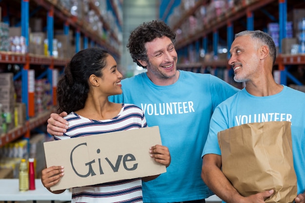 Happy volunteer are smiling and looking each other