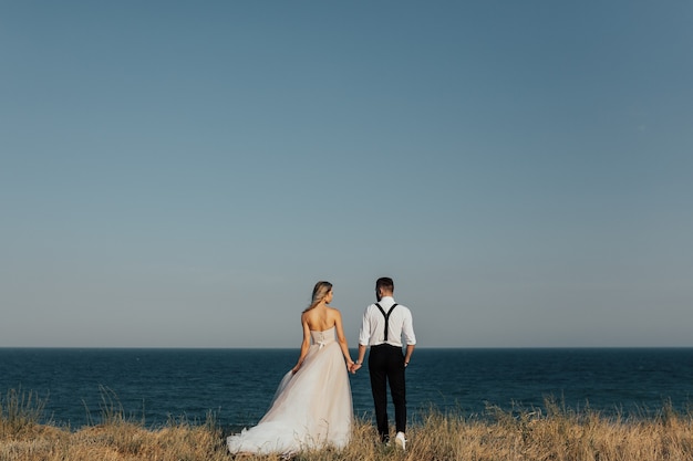 Happy wedding couple on sea beach.