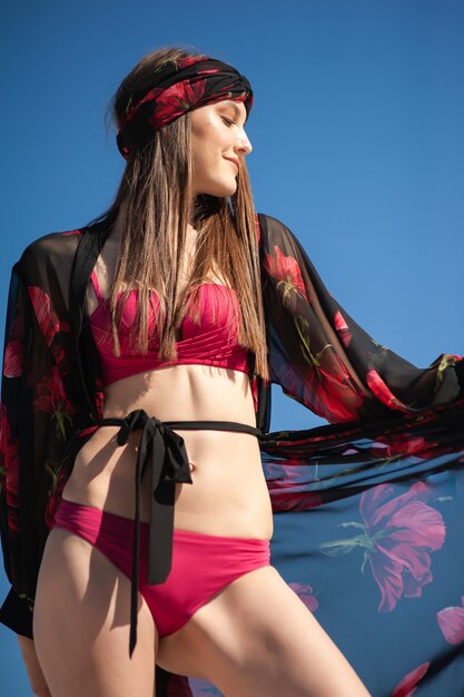 Happy woman on the beach wearing summer clothes