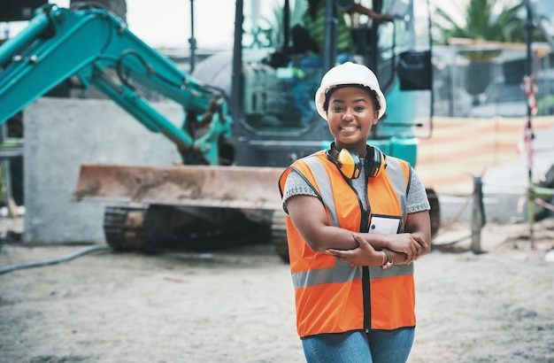 Happy woman construction worker with a ready to work smile on a job site outside Portrait of a proud young building development manager about to start working on engineering industrial plans