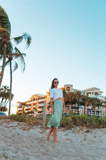 Happy woman enjoying beautiful sunset on the beach