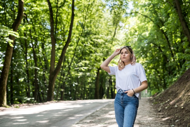 Happy woman in forest enjoy free summer time over woods background