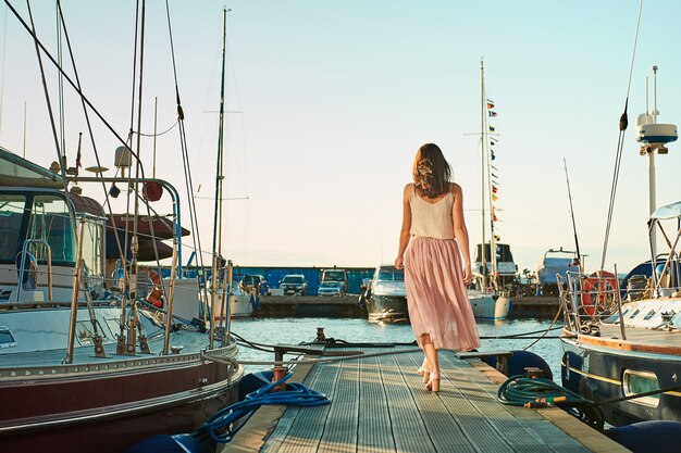 Happy woman going to the yacht