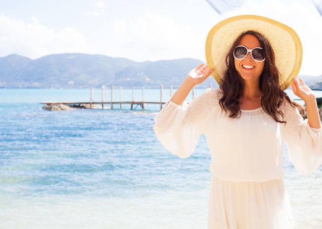 Happy woman in hat on the beach