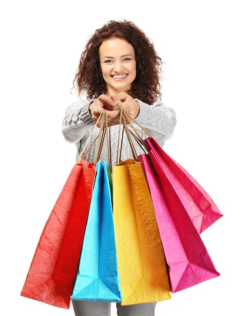 Happy woman holding shopping bags on white background