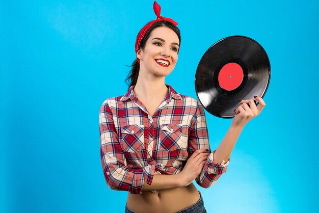 The happy woman holding a vinyl record on the blue background