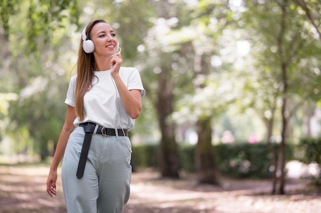 Happy woman listening to music through her headphones with copy space