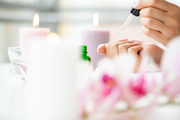 Happy woman making manicure when resting at home