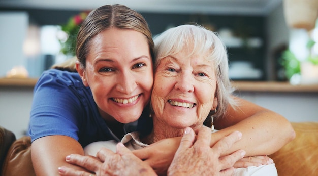 Happy woman portrait and hug with senior patient in elderly care love or nursing at retirement home Female person nurse or caregiver with smile for embrace healthcare or bonding at old age house