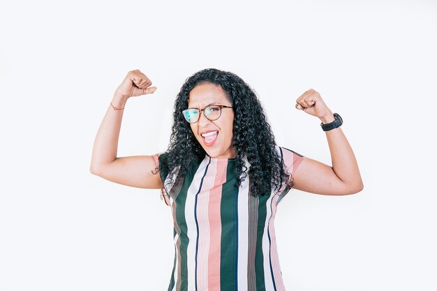 Happy woman raising arms in victory gesture isolated Winning people celebrating triumph Excited afro girl raising arms celebrating victory