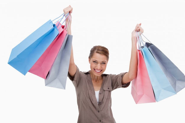 Happy woman raising her shopping bags