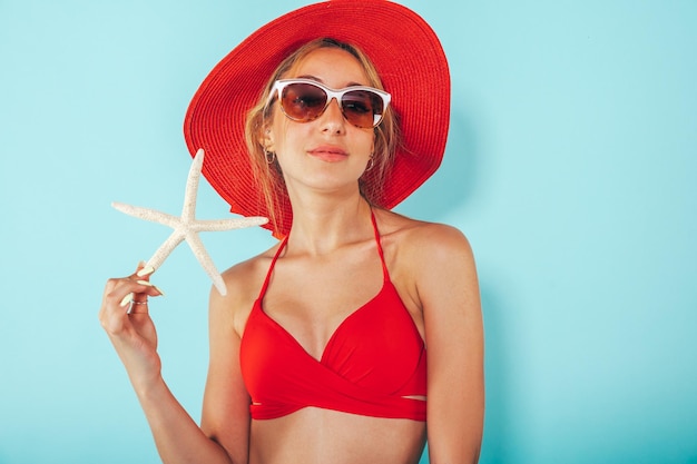 Happy woman ready to the summer with starfish in hand