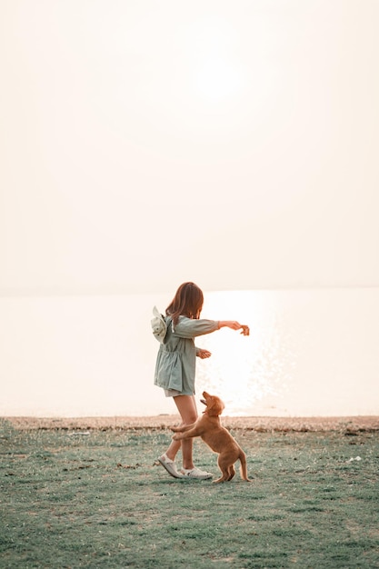 Happy woman relaxing with a dog in the holiday morning traveling and slow life resting style camping selective and soft focus