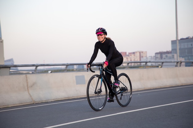 happy woman rides a bicycle