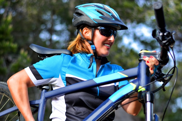 Happy woman riding mountain bike 