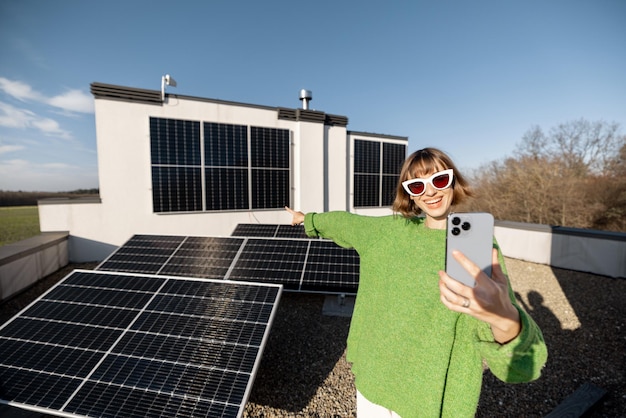 Happy woman on rooftop with a solar station