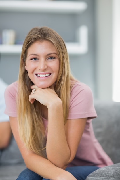 Happy woman sitting on couch