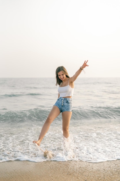 Happy woman smiling on the shore of the beach