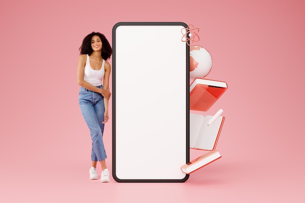 Happy woman standing near large mobile phone screen pink background