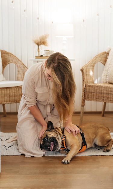 Happy woman in trailer playing with dog