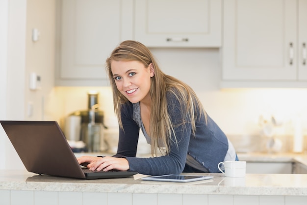 Happy woman using laptop