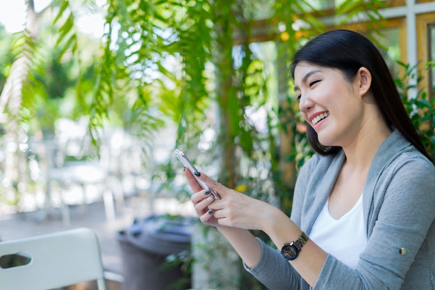 happy woman using smartphone shopping website online, shopping concept