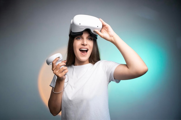 Happy woman using a virtual reality headset isolated on colorful background