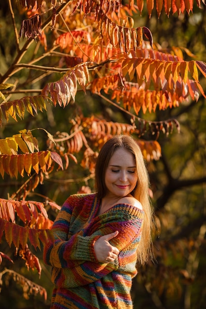 Happy woman wearing warm clothes in the park