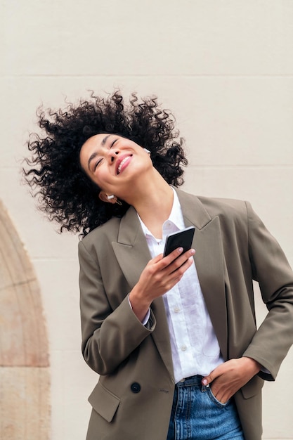 Happy woman with earphones dancing with the music