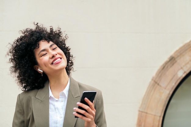 Happy woman with earphones smiles listening music