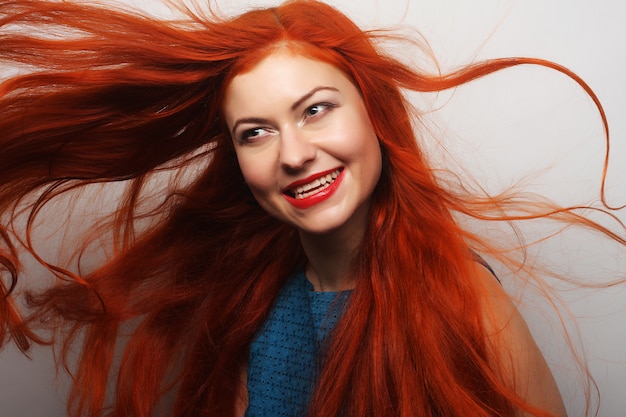 Happy woman with long flowing red hair