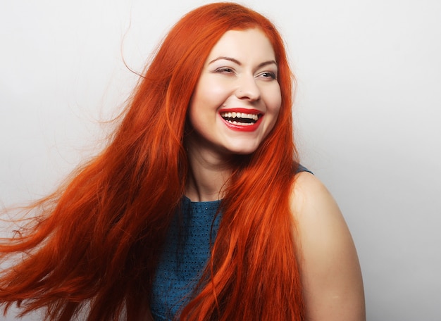 Happy woman with long flowing red hair