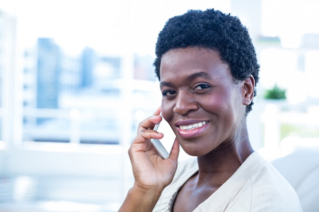 Happy woman with mobile phone at home