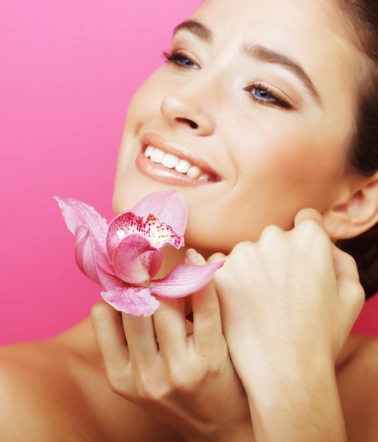 Happy woman with orchid flower