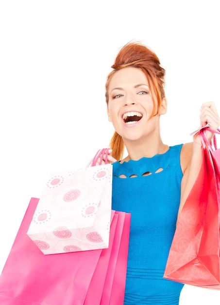 happy woman with shopping bags over white