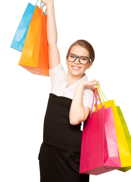 happy woman with shopping bags over white