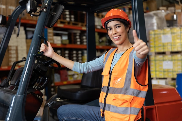 Happy woman worker warehouse staff forklift driver happy smiling enjoy working Asian people