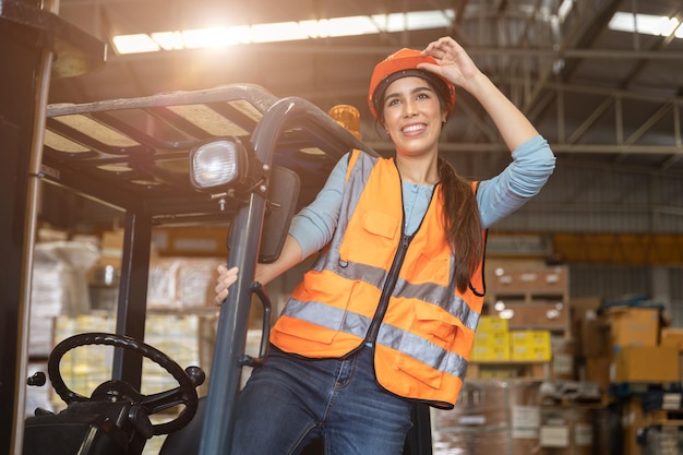 Happy woman worker warehouse staff forklift driver happy smiling enjoy working Asian people