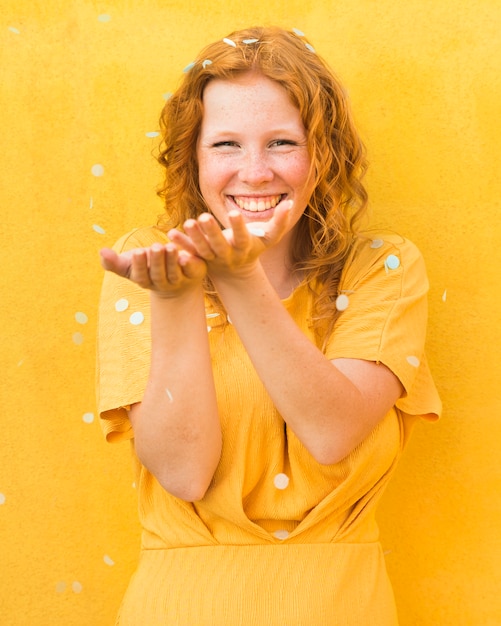 Happy woman yellow background