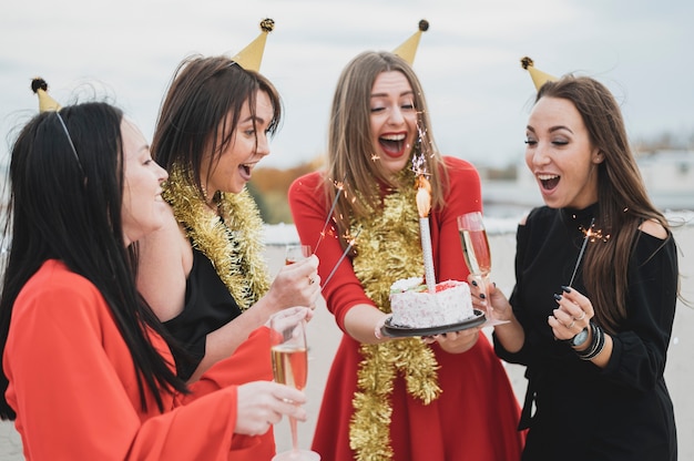 Happy women holding a birthday cake