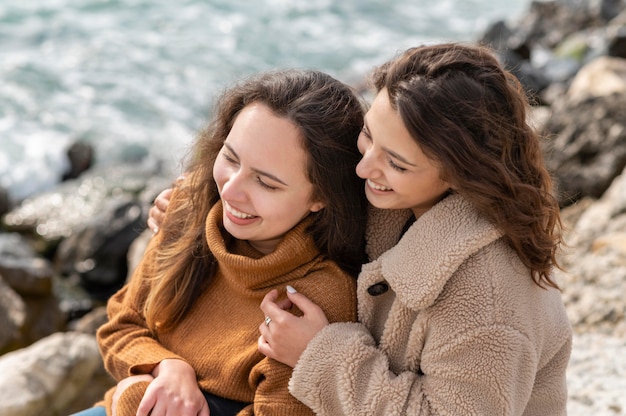 Happy women posing together on rock