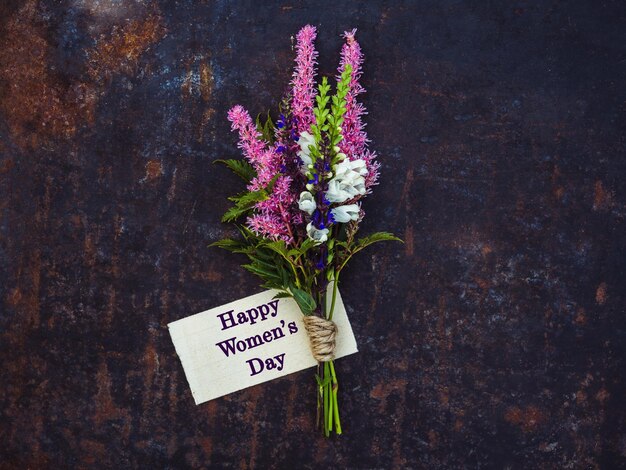 Happy Women's Day Beautiful flowers and congratulatory inscription