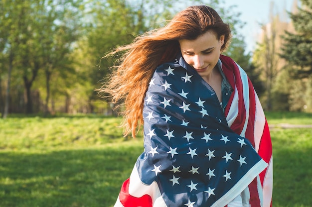 Happy women with American flag USA celebrate 4th of July