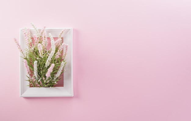 Happy Womens Day decoration concept made from flower and picture frame on pink pastel background